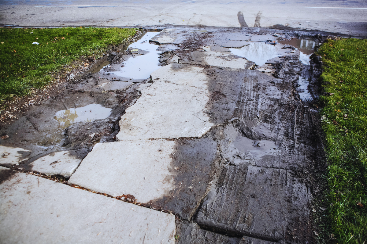 severely damaged driveway in need of full concrete replacement
