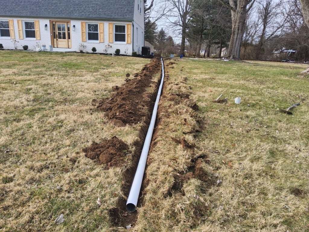 Columbus yard drainage company installing extension pipe underground